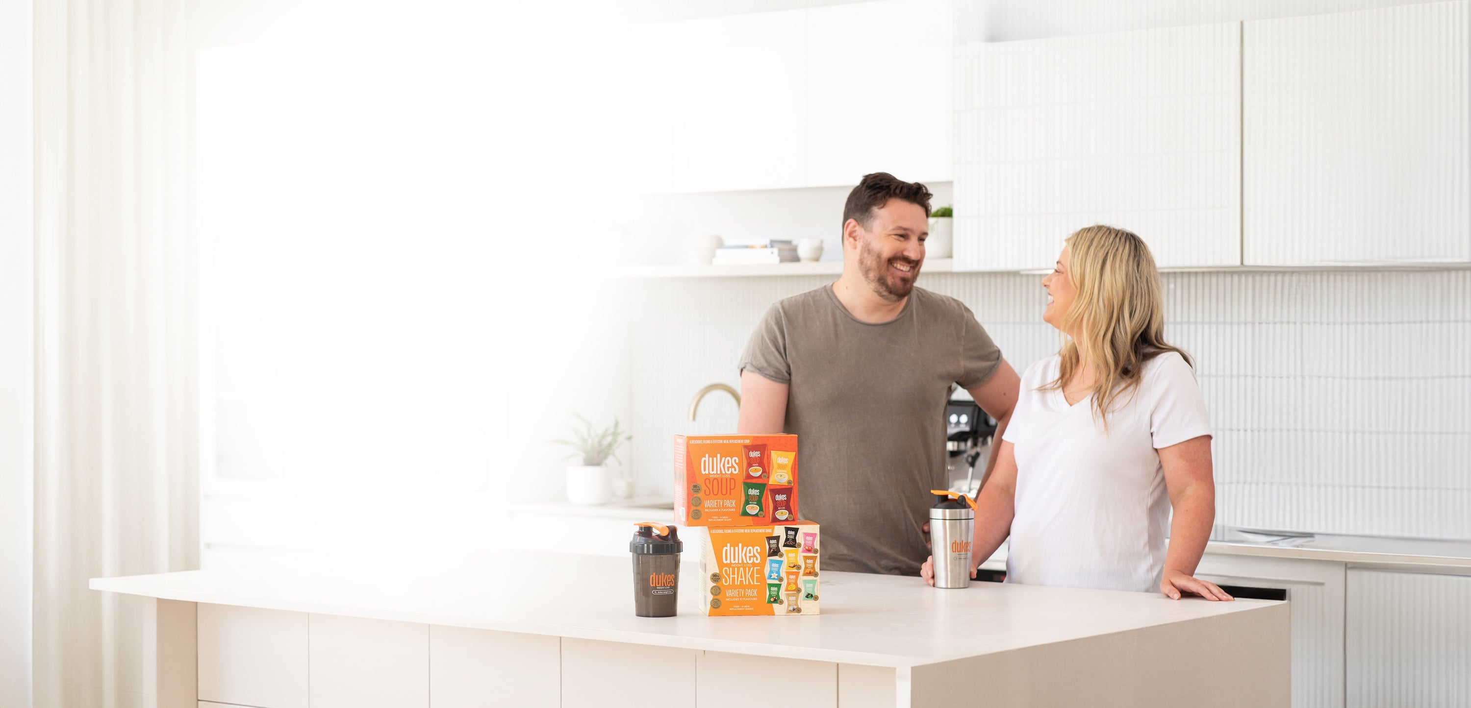 Man and Lady in a kitchen with a weight loss shake